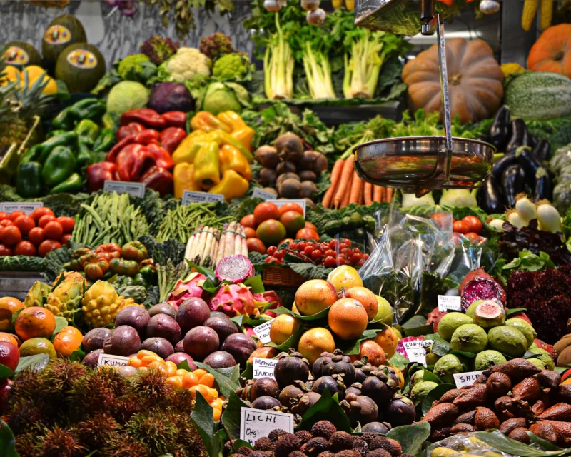 Colorful fresh fruits and vegetables at a market stall