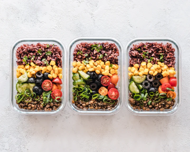 Meal prep containers filled with vegetables, grains and protein for weight loss