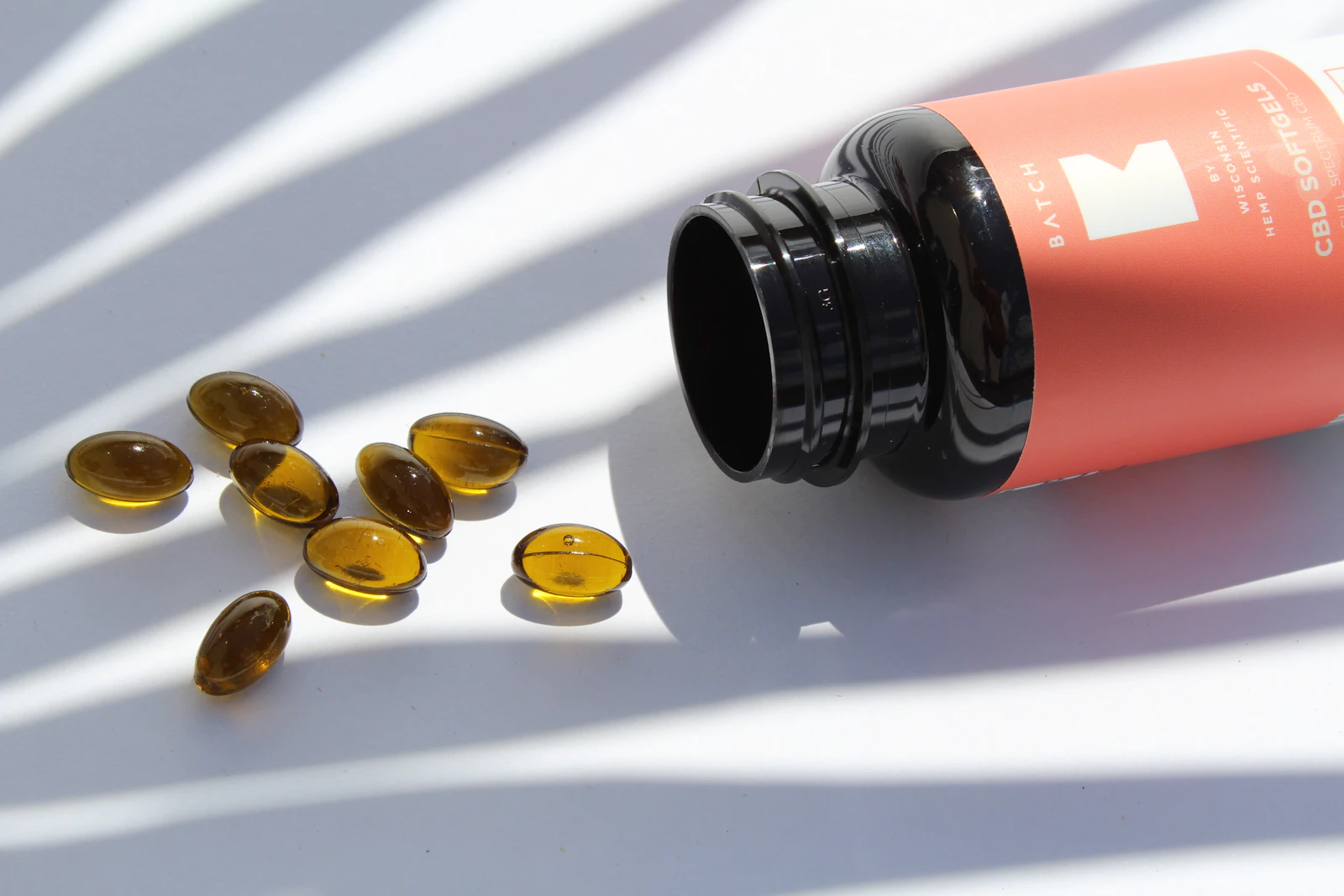 Softgel supplement capsules laid out on a white background